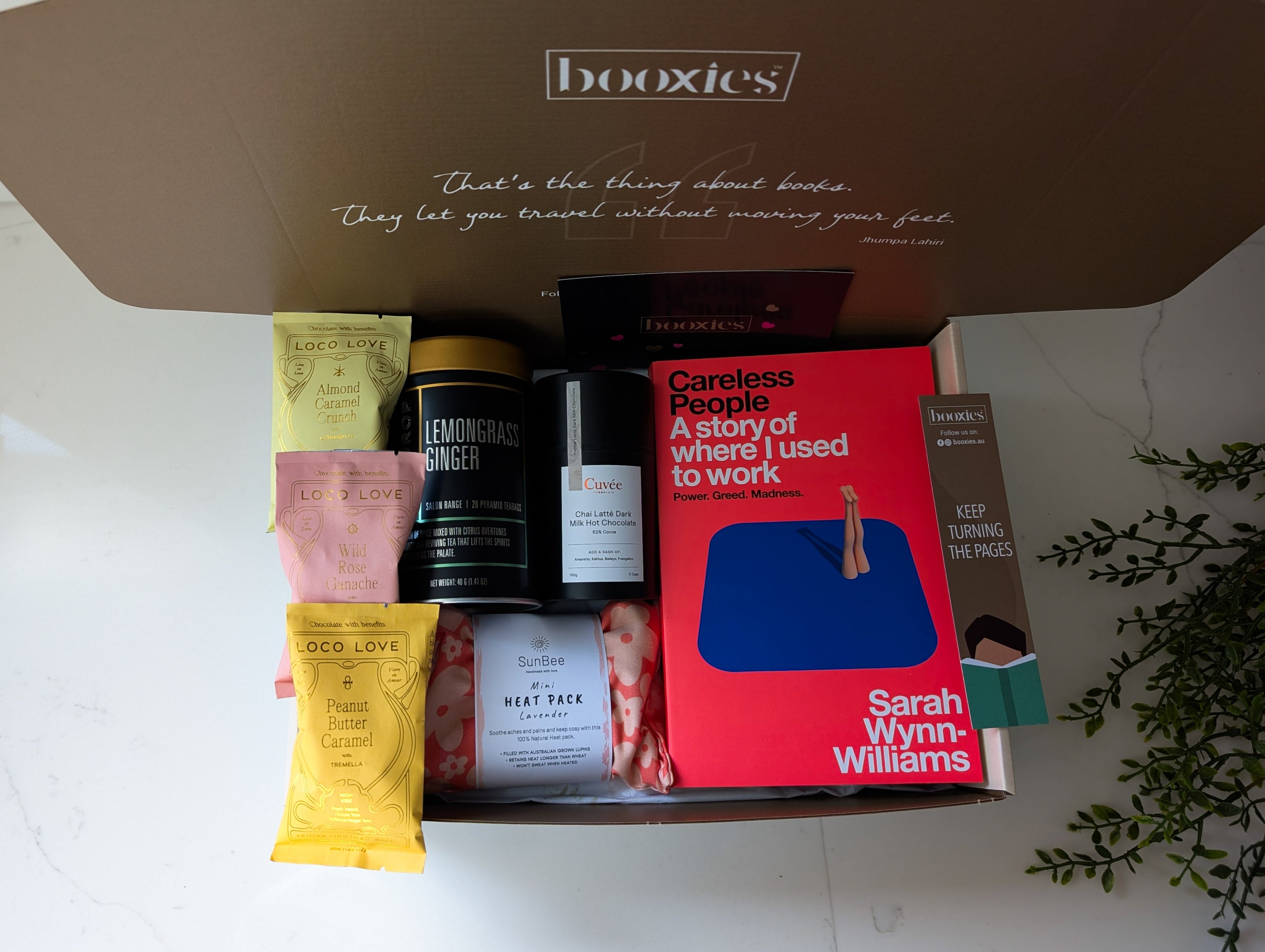 a warm hug booxies gift box including a book from your favourite genre, tea, hot chocolate or chai hot chocolcate, 3x vegan organic chocolate, lavendar heat pack, a bookmark and greeting card