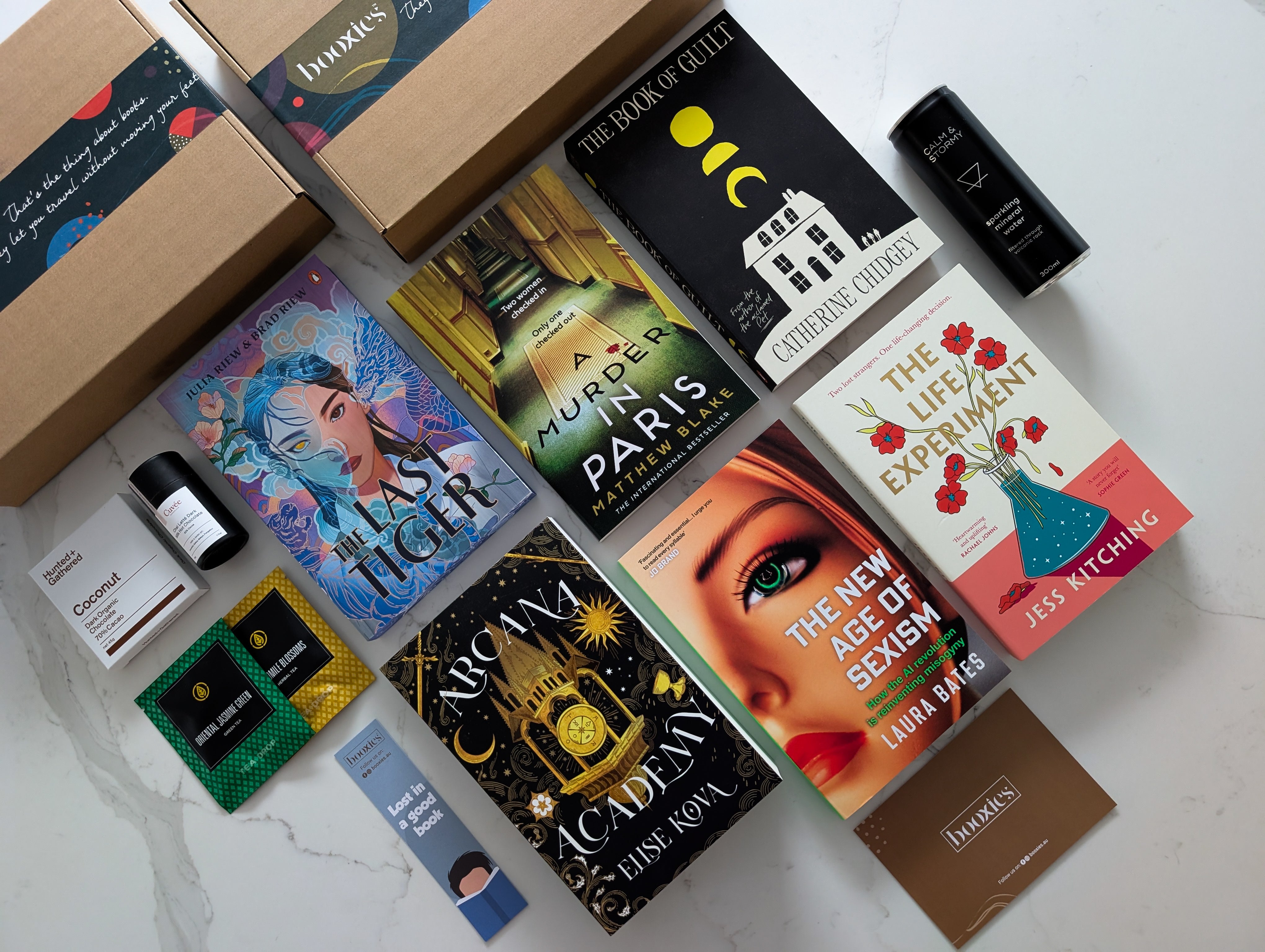 September 2025 Mystery Booxies book subscription books and product selection on layed on a white background