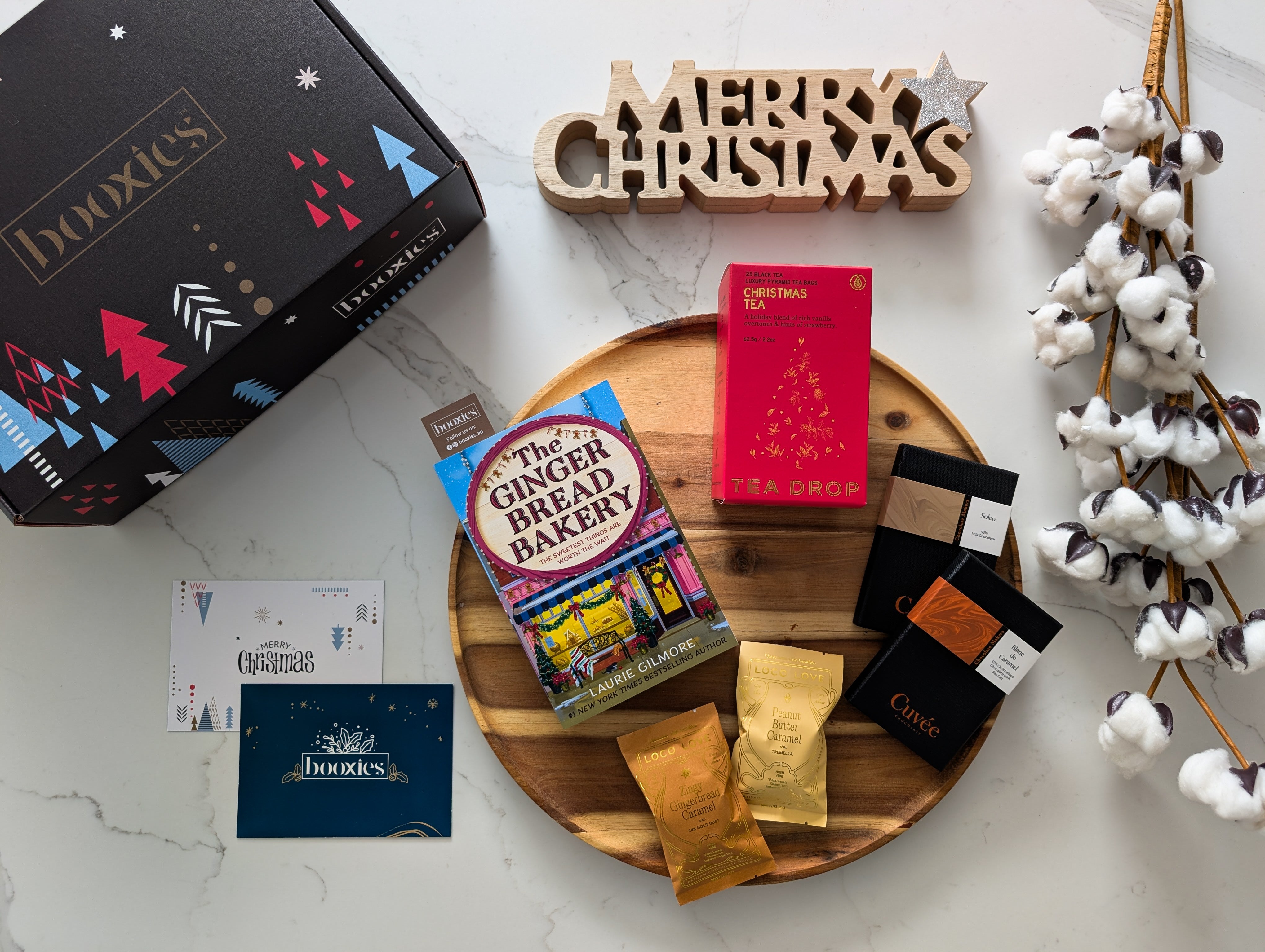 collection of hand picked products with a book on a white background making a christmas gift from Booxies