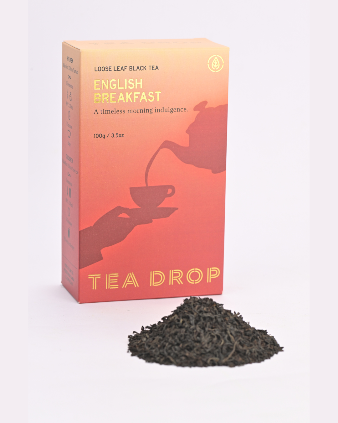 Tea box labeled 'Tea Drop' with loose leaf black tea on a white background