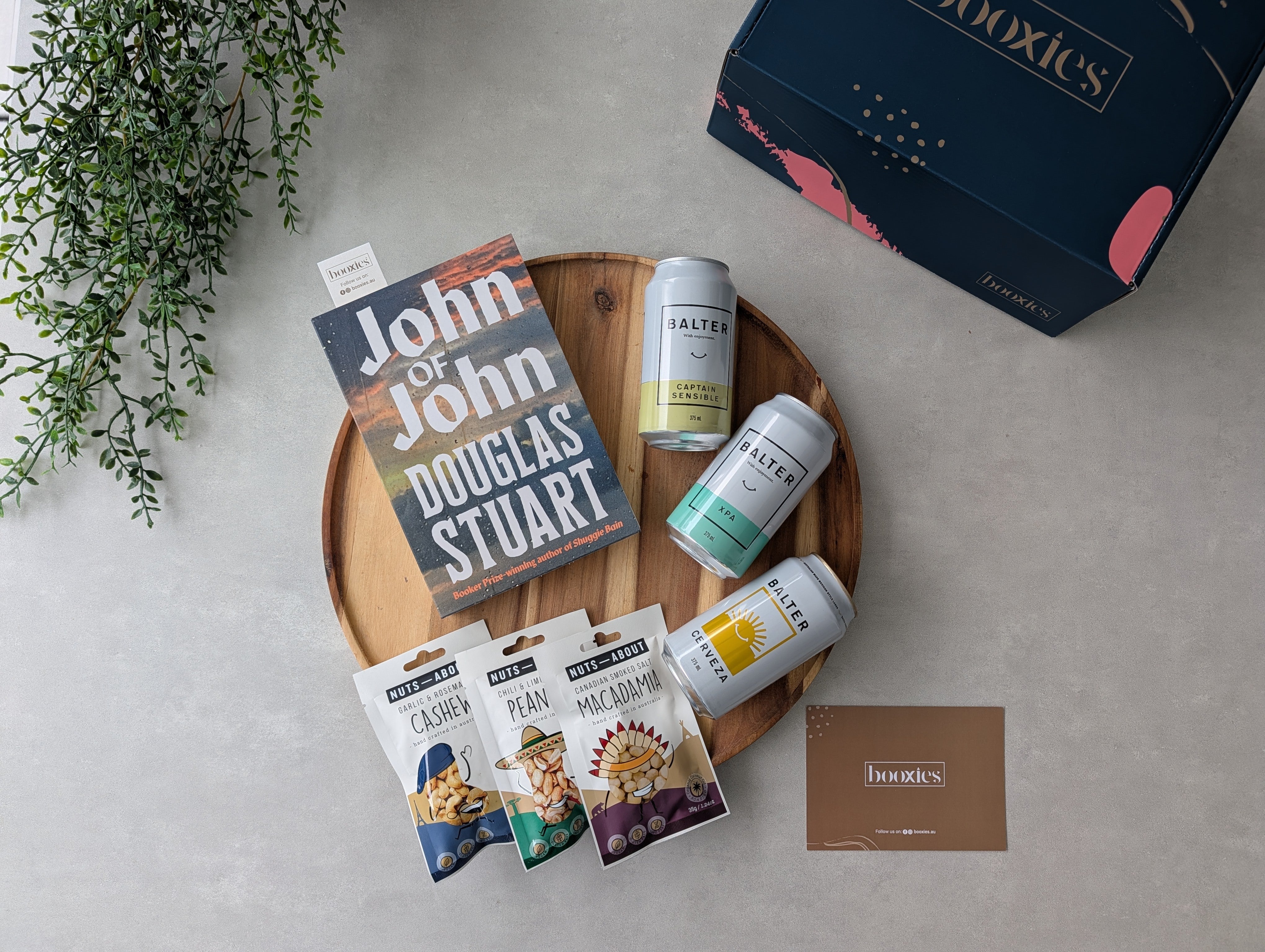 happy hours crafted beer and roasted nuts and books gift box on a flatlay
