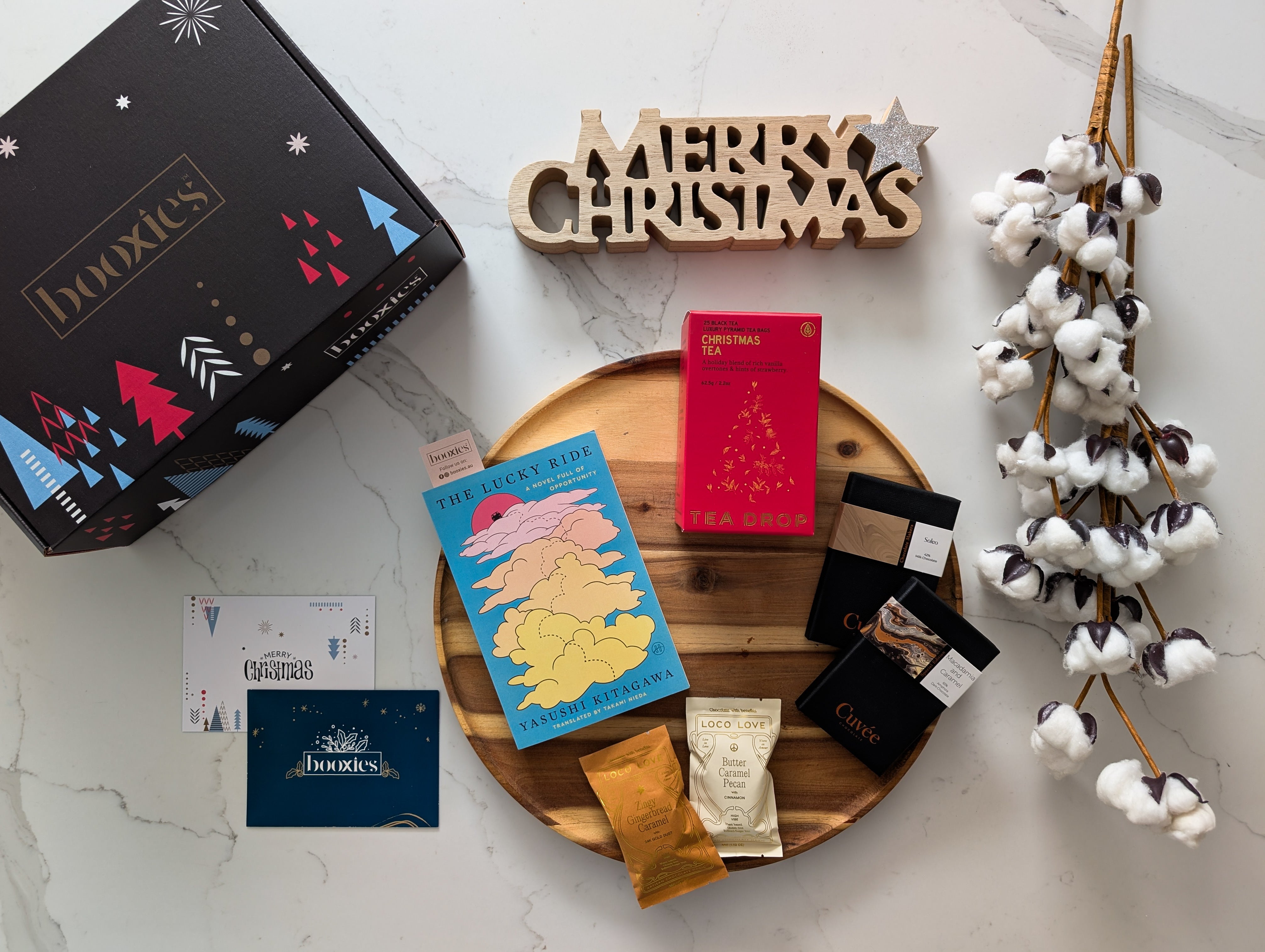 collection of hand picked products with a book on a white background making a christmas gift from Booxies