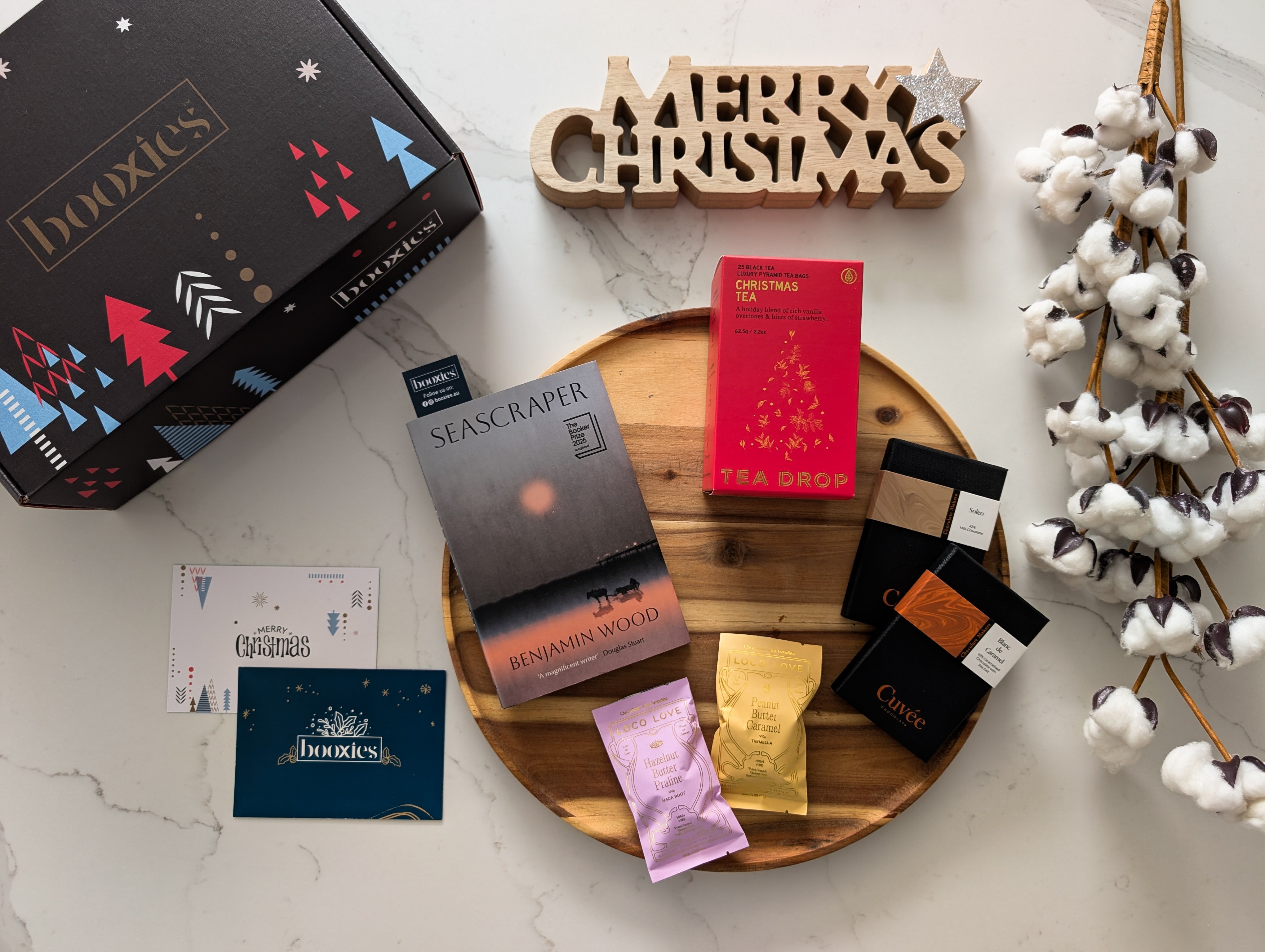 collection of hand picked products with a book on a white background making a christmas gift from Booxies