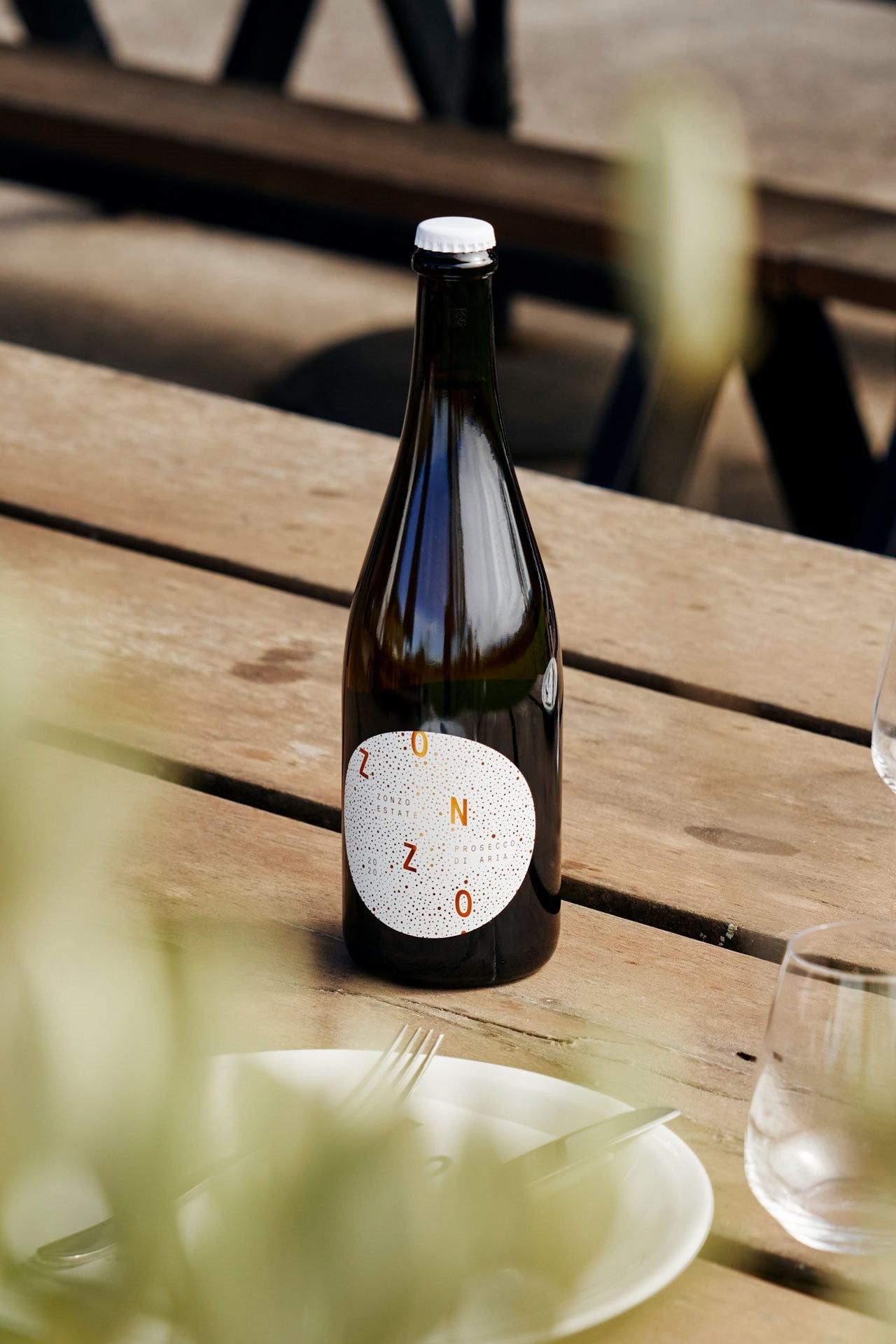 Bottle of Zuno on a wooden table with a blurred background